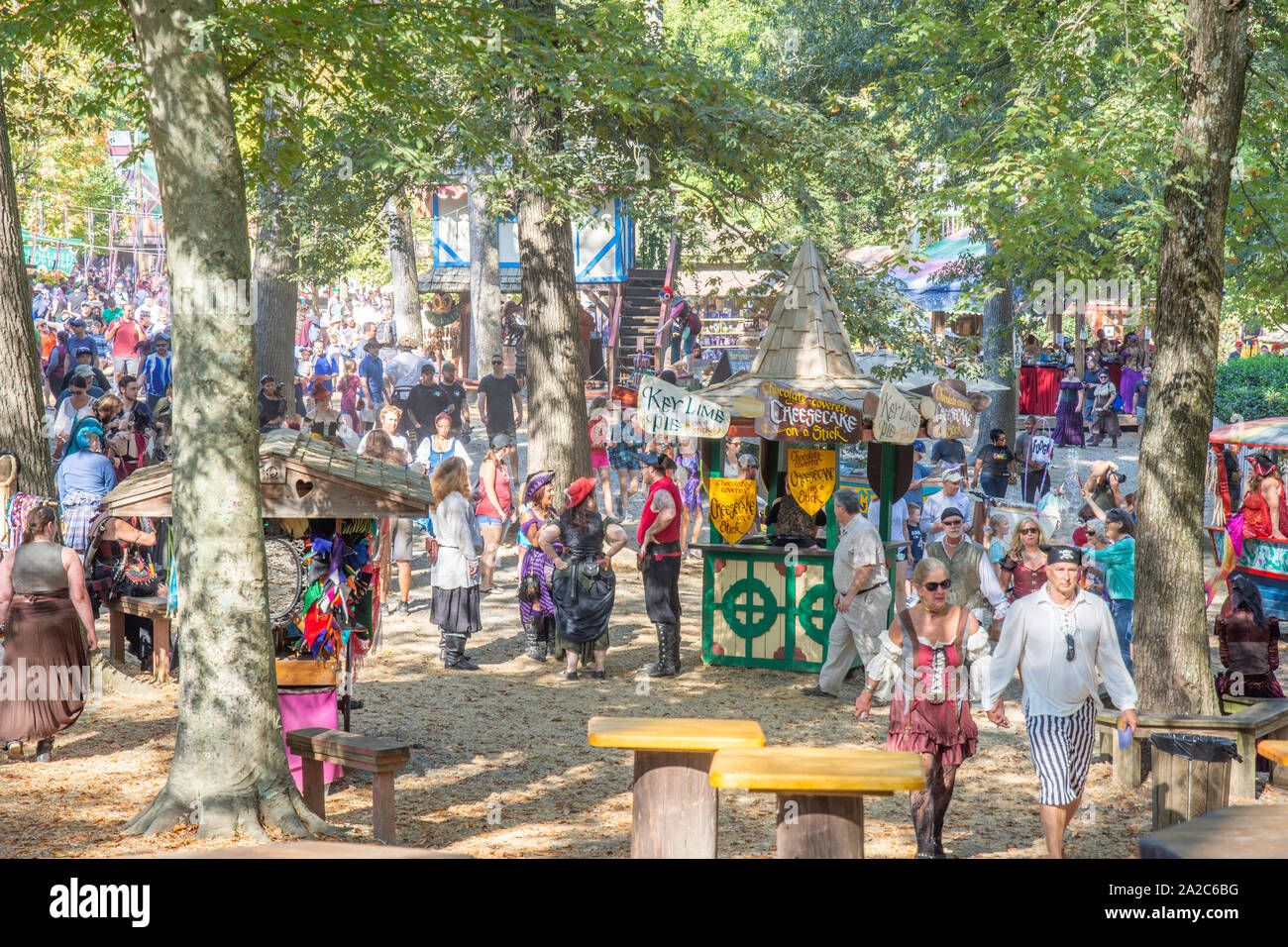 Visitors, some in costume, enjoy the bucolic setting at the annual Maryland Renaissance Festival in Crownsville, MD. Stock Photo