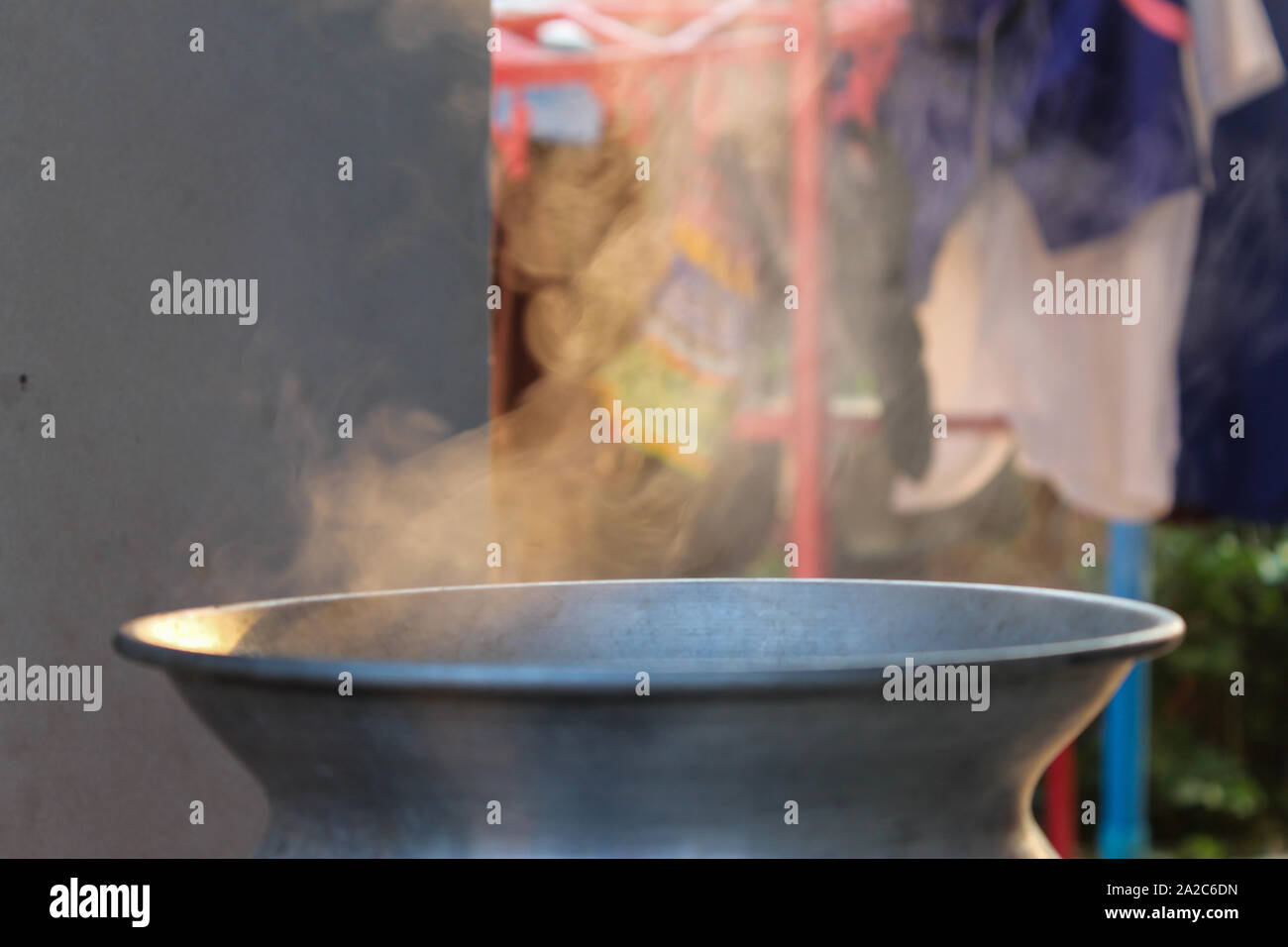 Traditional silver steamer pot with white smoke while cooking Stock Photo