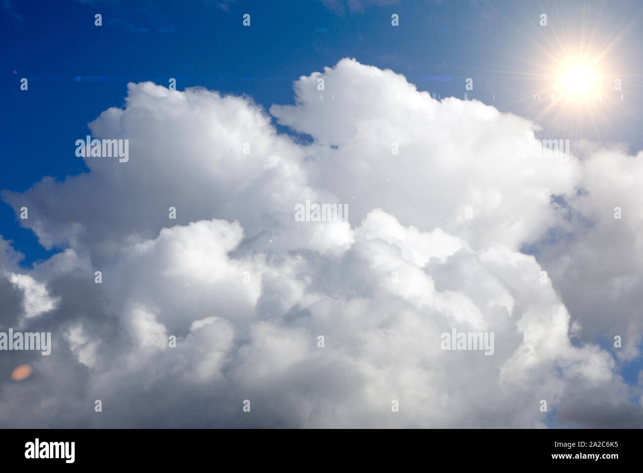 White clouds on a bright sunny day Stock Photo - Alamy