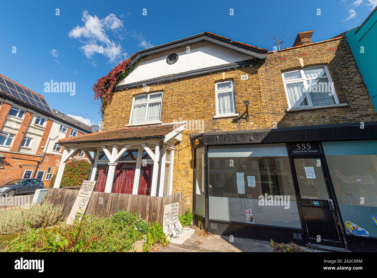 Old building in London Road, Westcliff on Sea, Essex, UK due for development into flats with Charlie Brown Peanuts cartoon characters on protest board Stock Photo
