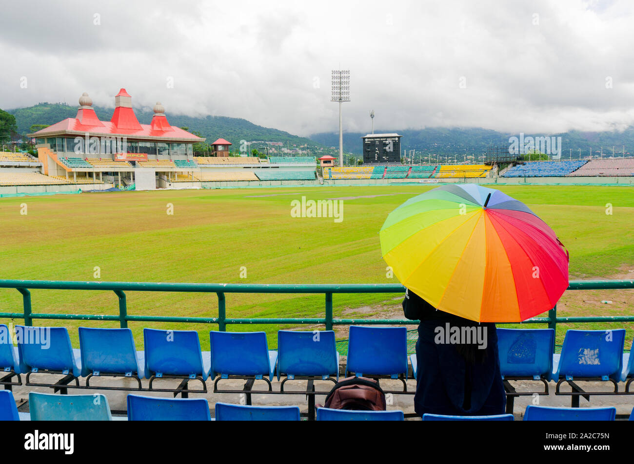 colorful umbrella on the seats of Dharamshala himachal cricket stadium Stock Photo Alamy