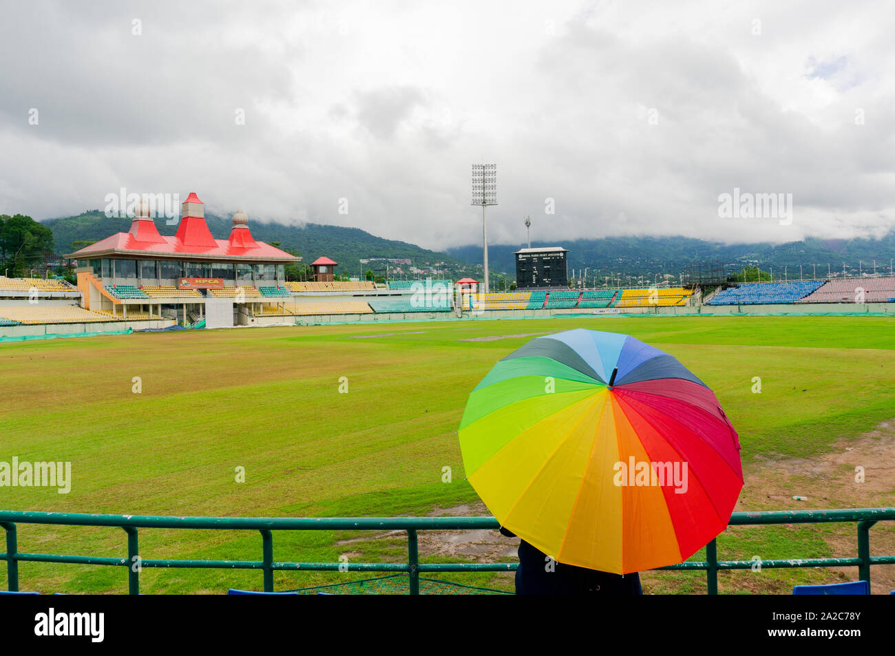 colorful umbrella on the seats of Dharamshala himachal cricket stadium Stock Photo