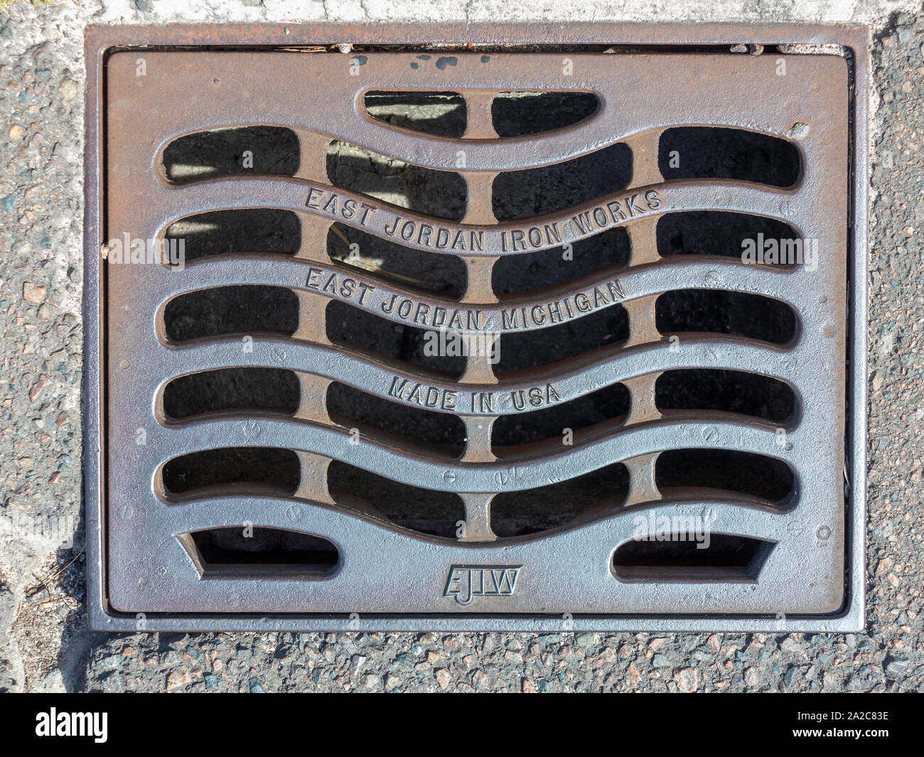 USA made iron drain cover on a road in Bermuda Stock Photo