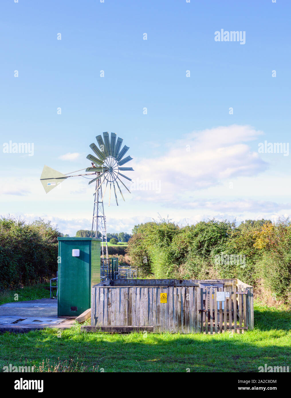 A water pumping station on the outskirts of Lytham St Anne's, Lancashire, UK. The pump runs on electricity generated by a wind turbine Stock Photo