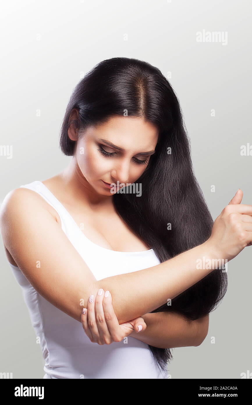 Body Pain. Woman Feeling Sharp Pain In Elbows. Portrait Of Beautiful