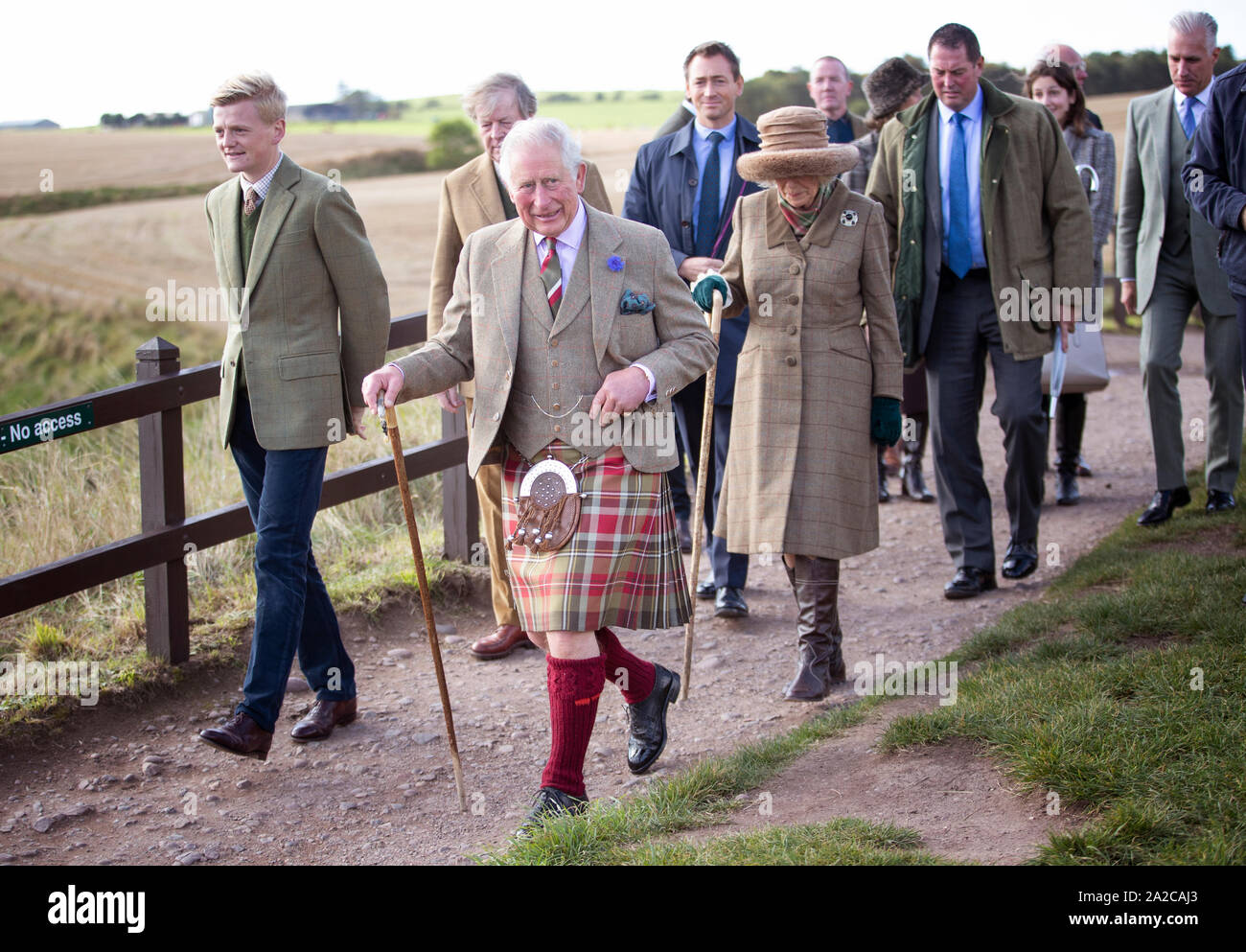 The Prince of Wales and Duchess of Cornwall, known as the Duke and Duchess of Rothesay while in Scotland, accompanied by castle owner George Pearson (front left), during a visit to Dunnottar Castle, the cliff top fortress which was once the home of the Earls Marischal, near Stonehaven. Stock Photo