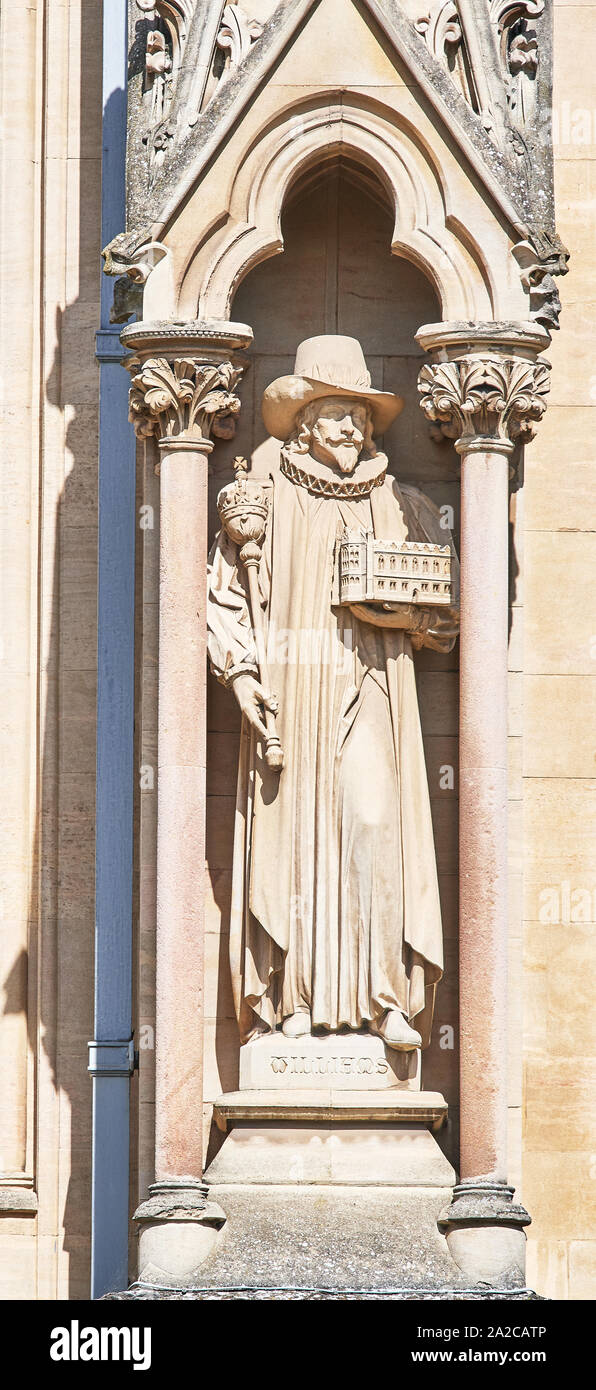 Stone state of a benefactor, Williams, on the outside wall of the chapel at the college of St John, university of Cambridge, England. Stock Photo