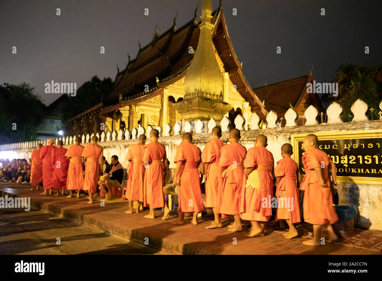 Tak bat Monks call to alms at dawn, Luang Prabang, Luang Prabang province, Northern Laos, Laos, Southeast Asia Stock Photo