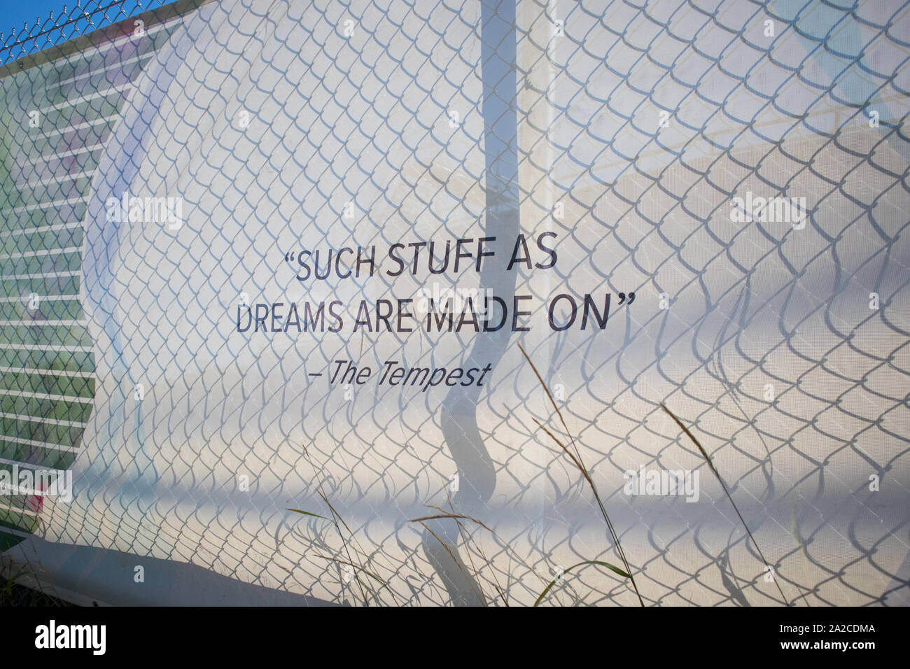 Fences hiding the site of the Tom Patterson new theater. The quote 'Such stuff as dreams are made on' is from Shakespeare's The Tempest Act 4. Stock Photo