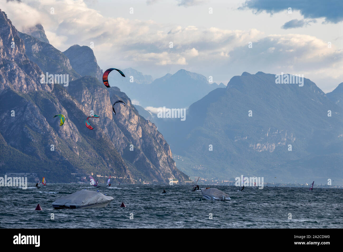MALCESINE, ITALY - JUNE 13, 2019: The windsurfers on the Lago di Garda. Stock Photo