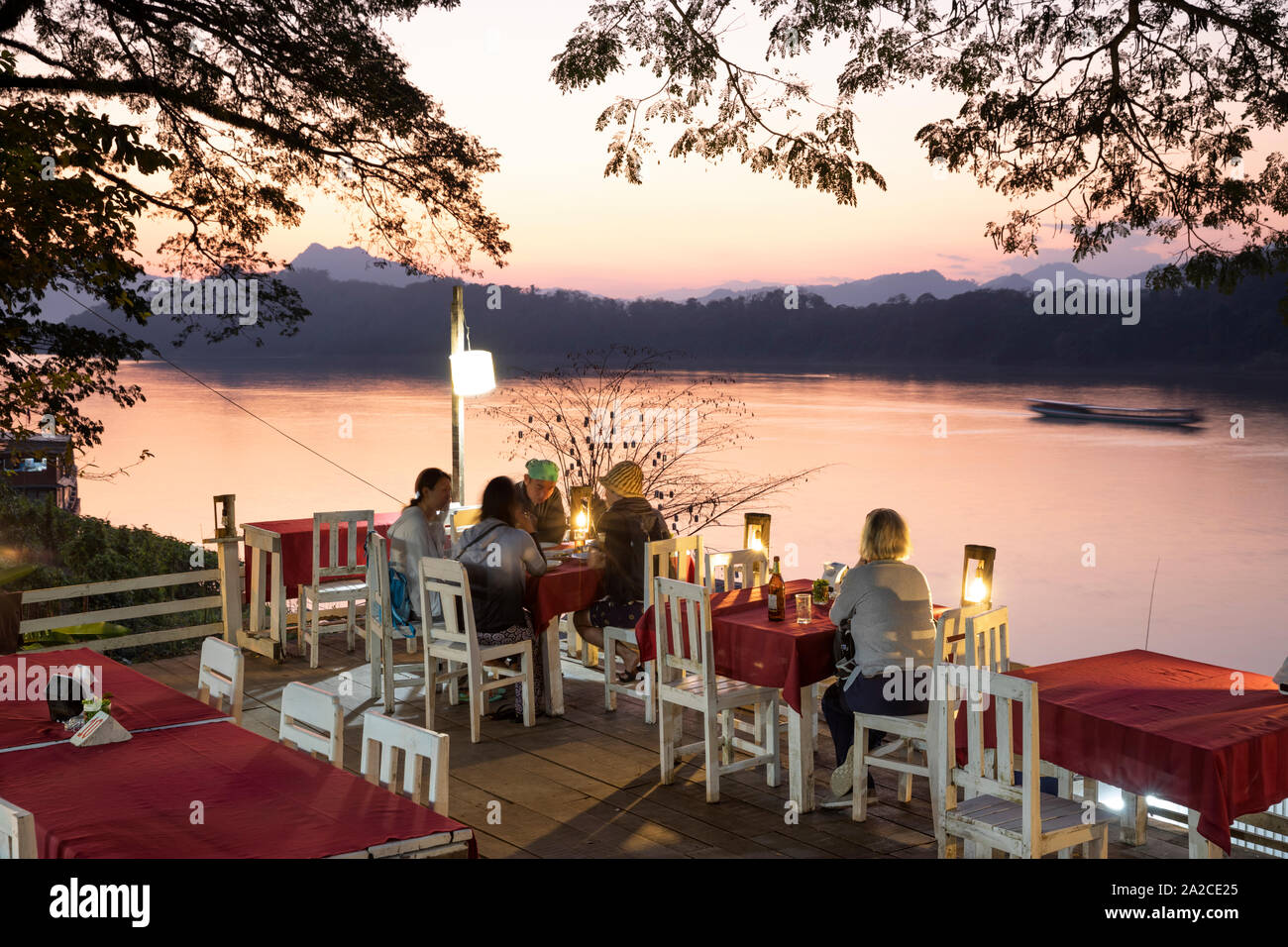 Restaurant and bar beside the Mekong river at sunset, Luang Prabang, Luang Prabang province, Northern Laos, Laos, Southeast Asia Stock Photo