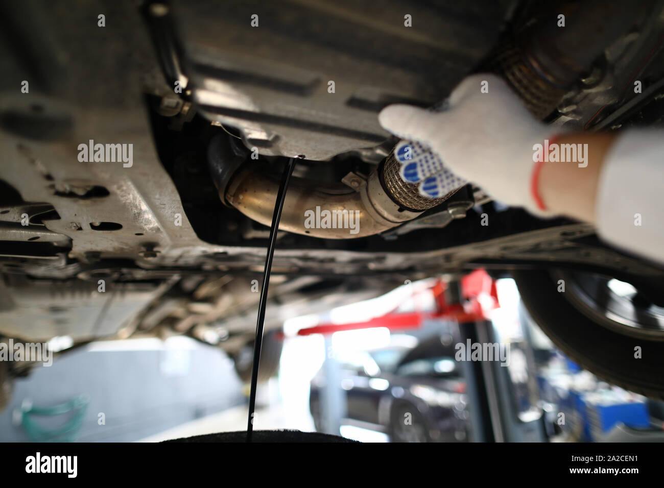 Black jet of used engine oil drains from the engine Stock Photo Alamy