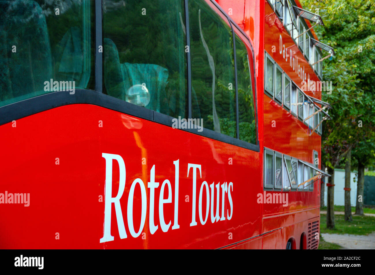 Huge red Mercedes bus, Rotel Tours, in the Italian Dolomites, Canazei, Italy Stock Photo