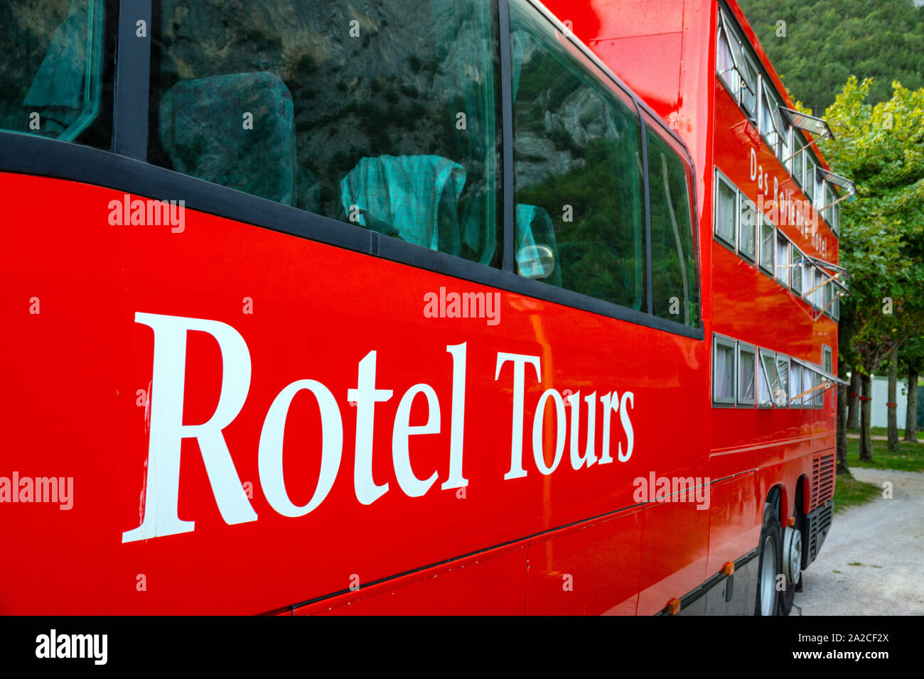 Huge red Mercedes bus, Rotel Tours, in the Italian Dolomites, Canazei, Italy Stock Photo