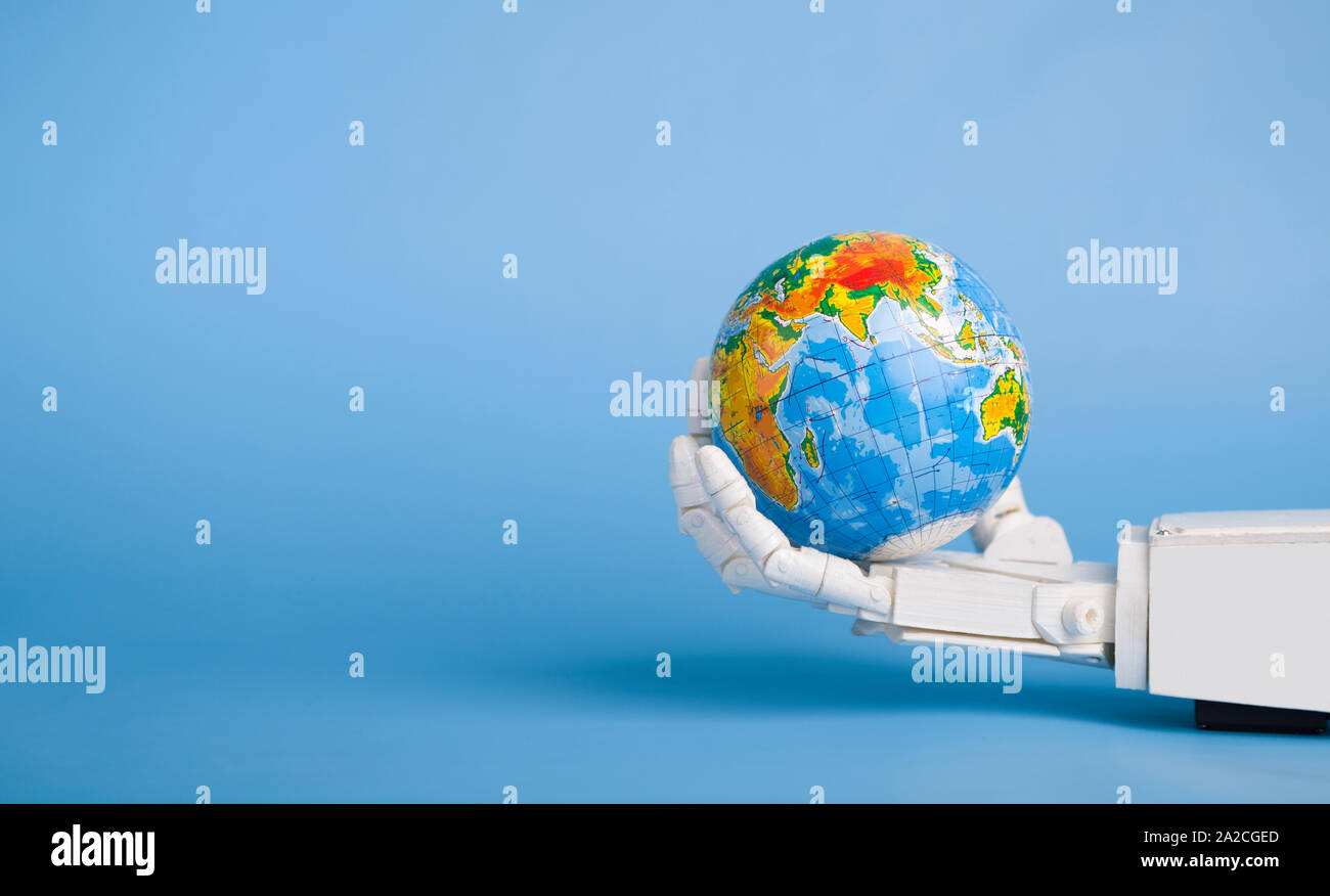 Earth globe in robotic hand, blue panorama background Stock Photo