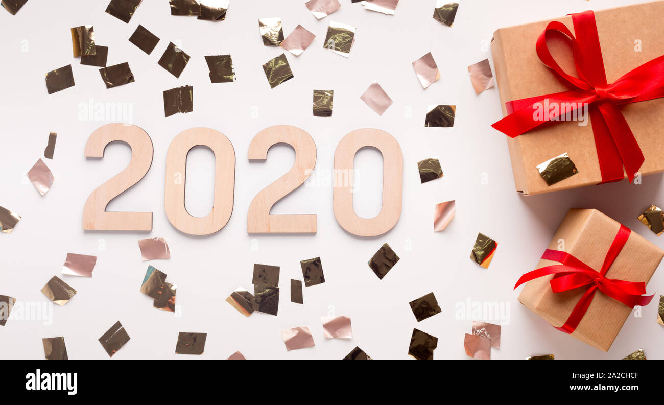 Wow 2020 New year concept with present boxes and gold confetti Stock Photo