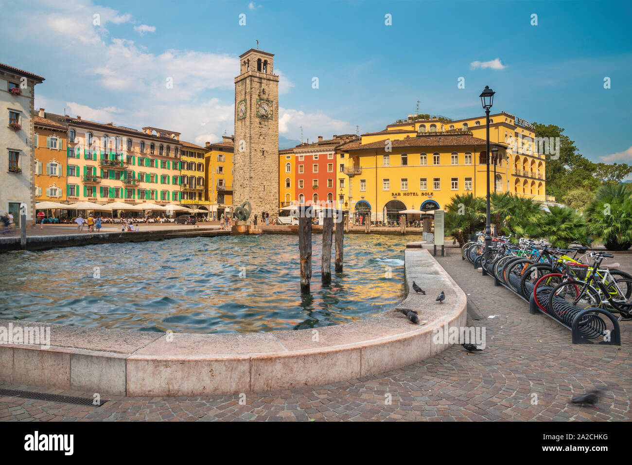RIVA DEL GARDA, ITALY - JUNE 6, 2019: The harbor and Torre Apponale tower. Stock Photo