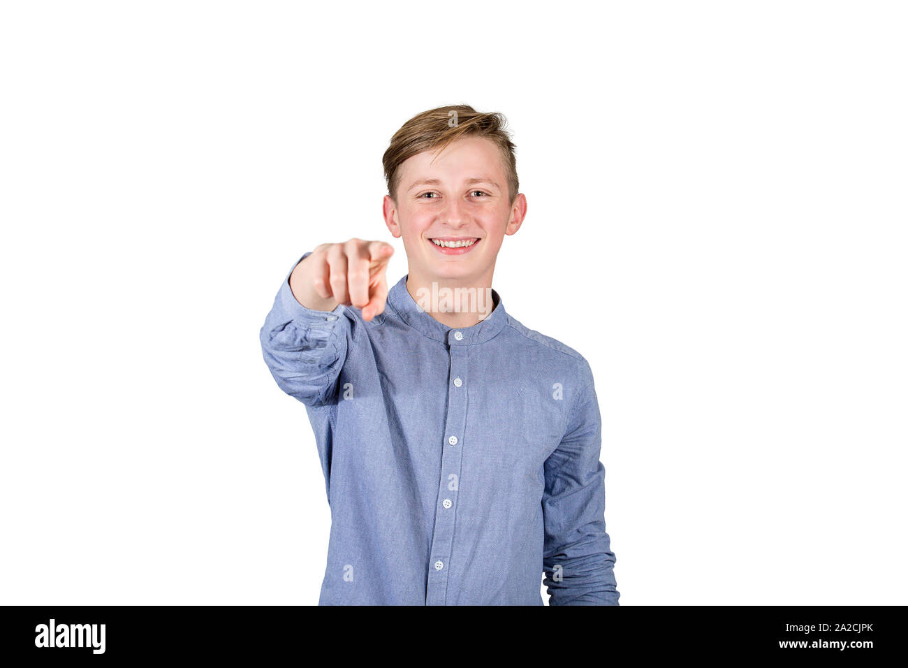 Joyful guy teenager pointing index finger looking to camera tooth smile isolated over white background. I choose you. Stock Photo
