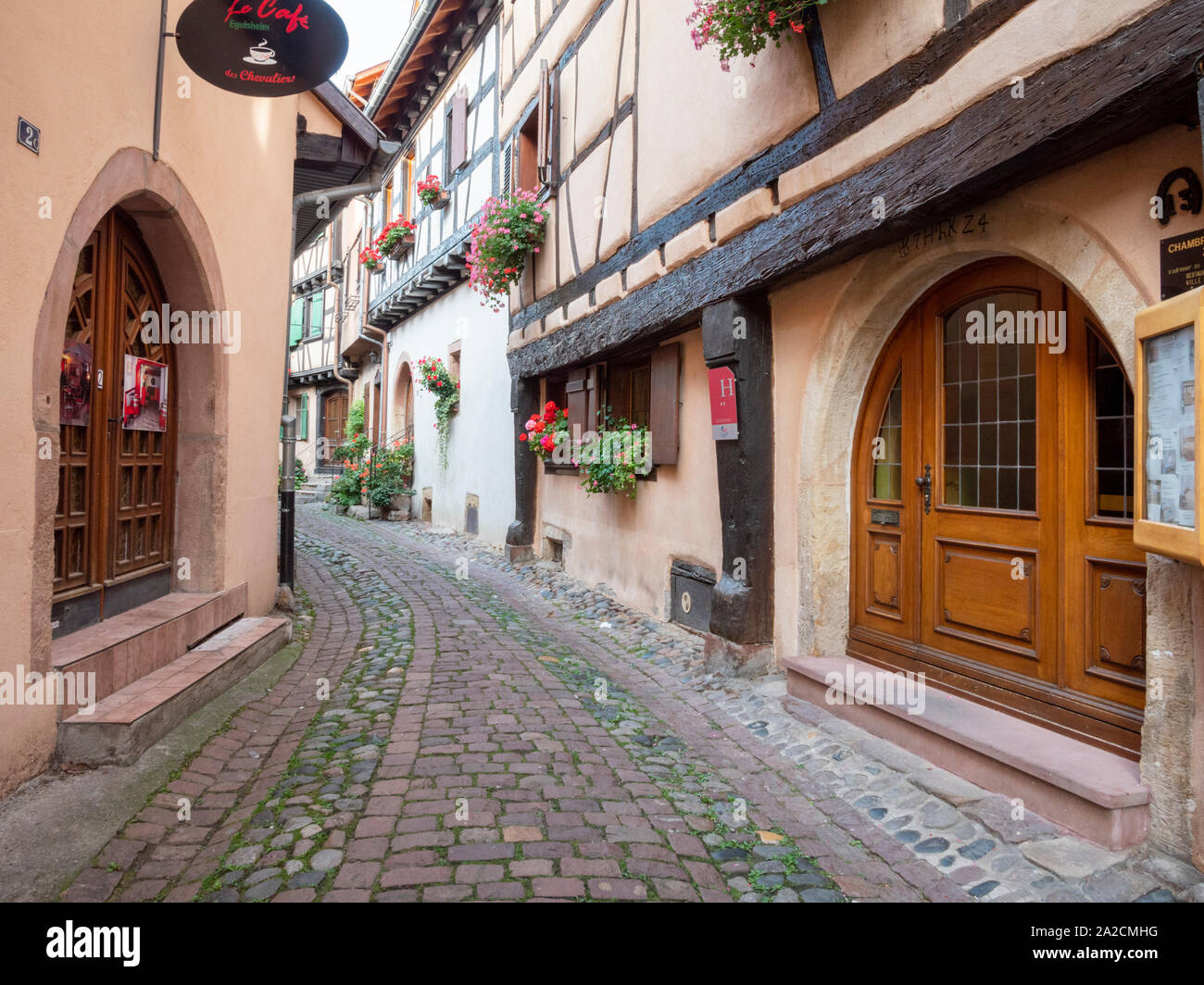 Half timbered buildings in the centre of Eguisheim Alsace France a pretty medieval town in the heart of the Alsace wine region and popular travel dest Stock Photo