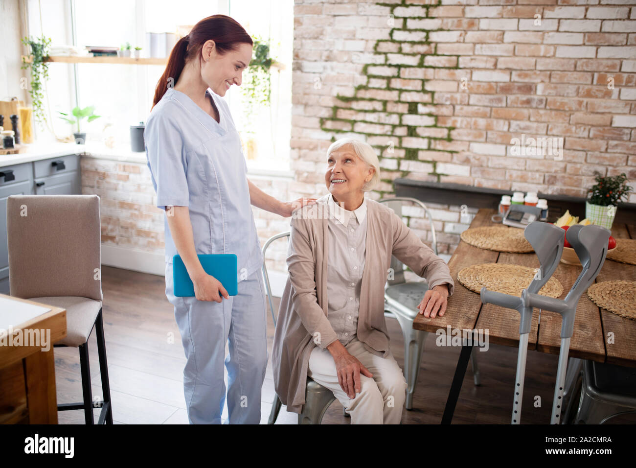 Elderly woman caregiver talking hi-res stock photography and images - Alamy