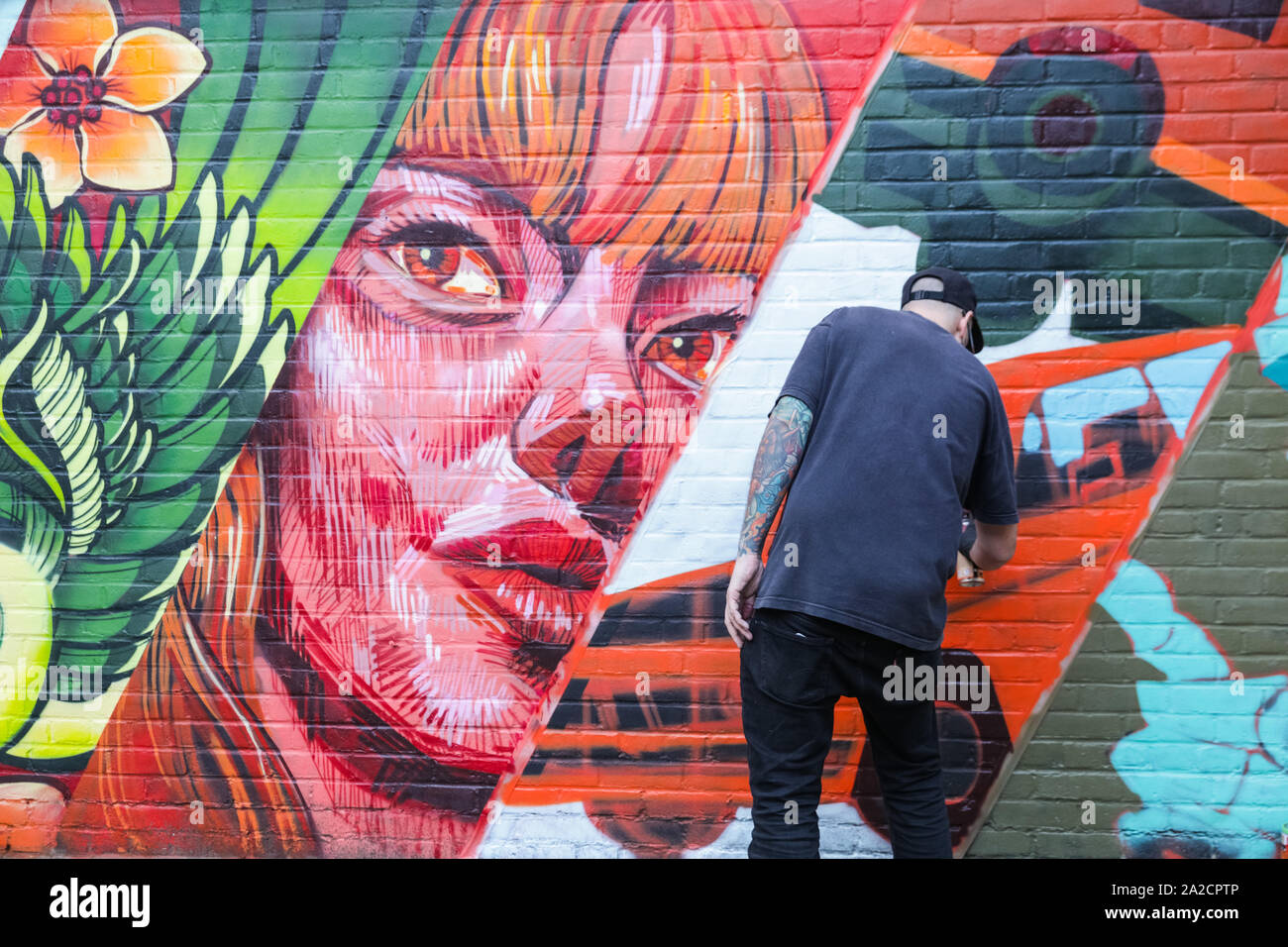 Chelsea Sorting Office, London, UK, 02 Oct 2019. A street artists works on an untitled piece outside the building. The 10th anniversary installation halls of Moniker Art Fair see the best of British urban artists, featuring a stellar roster of creatives, including acclaimed international artists making their UK debuts and Moniker’s own Spotlight Artists of 2019, with one hall's installations boldly respond to the looming shadow of Brexit Day. Credit: Imageplotter/Alamy Live News Stock Photo