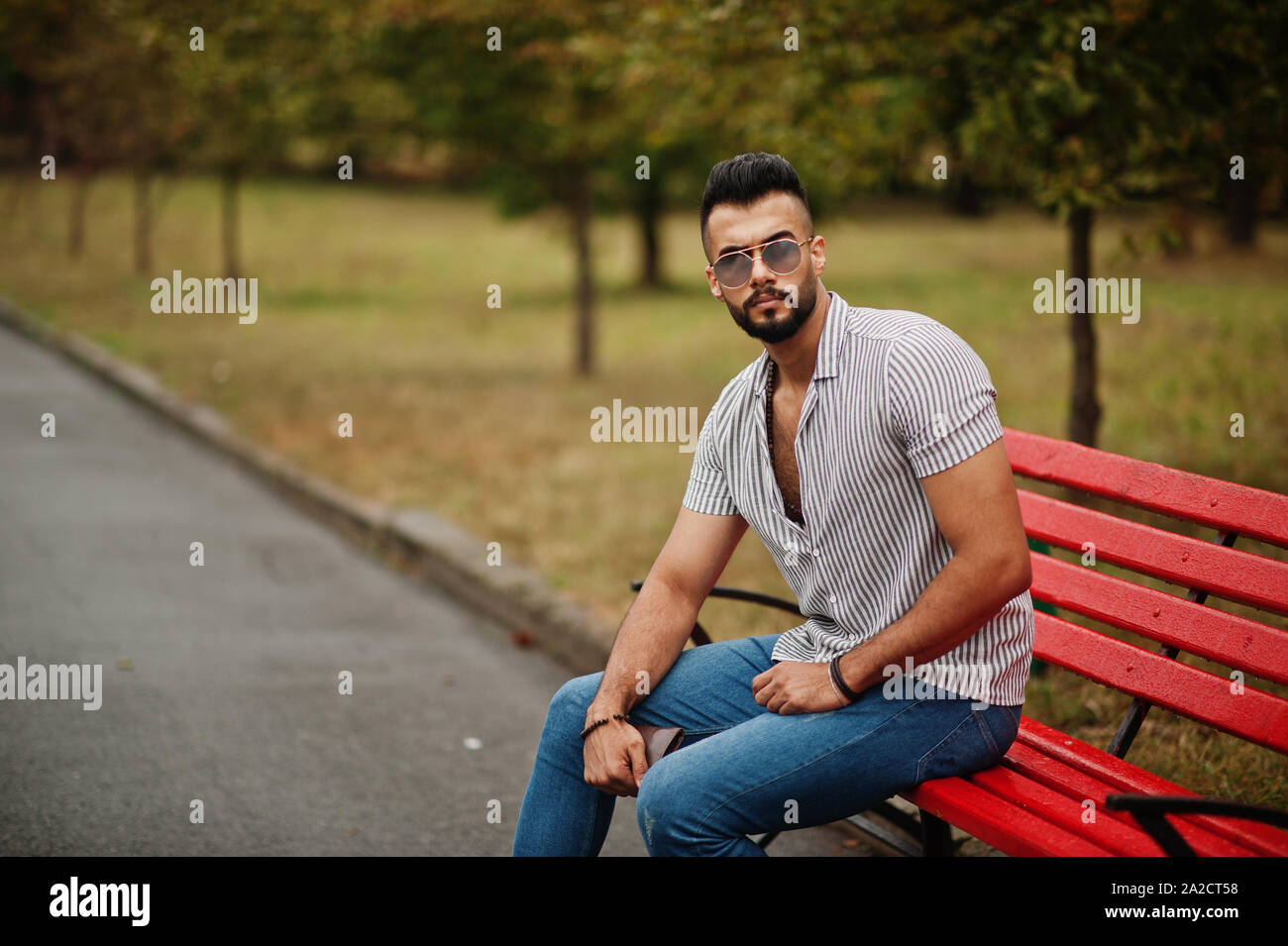 Arab man sitting on park bench hi-res stock photography and images - Alamy