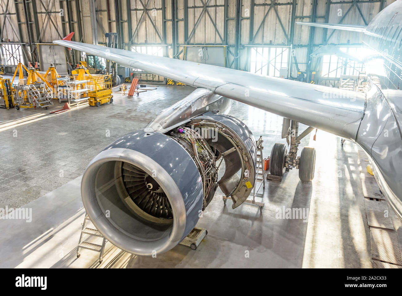 Opened aircraft engine in the hangar, maintenance. Wing view. Stock Photo