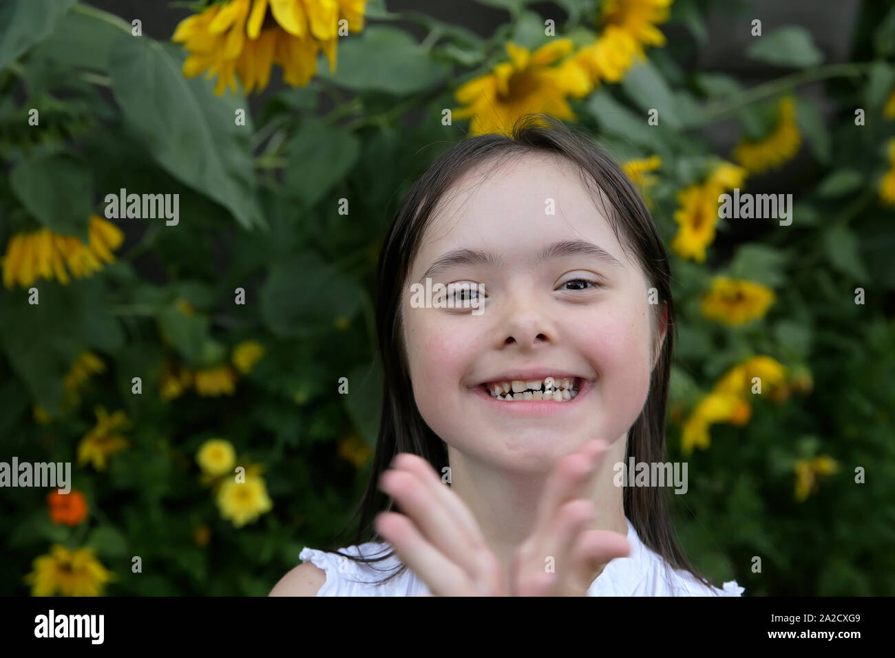 Portrait of little girl smiling in the garden Stock Photo - Alamy
