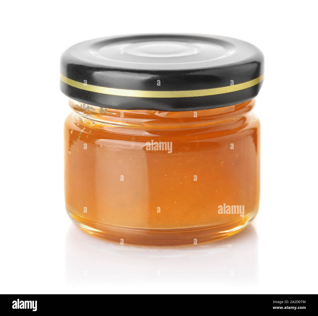 Small glass jar of apricot jam isolated on white Stock Photo