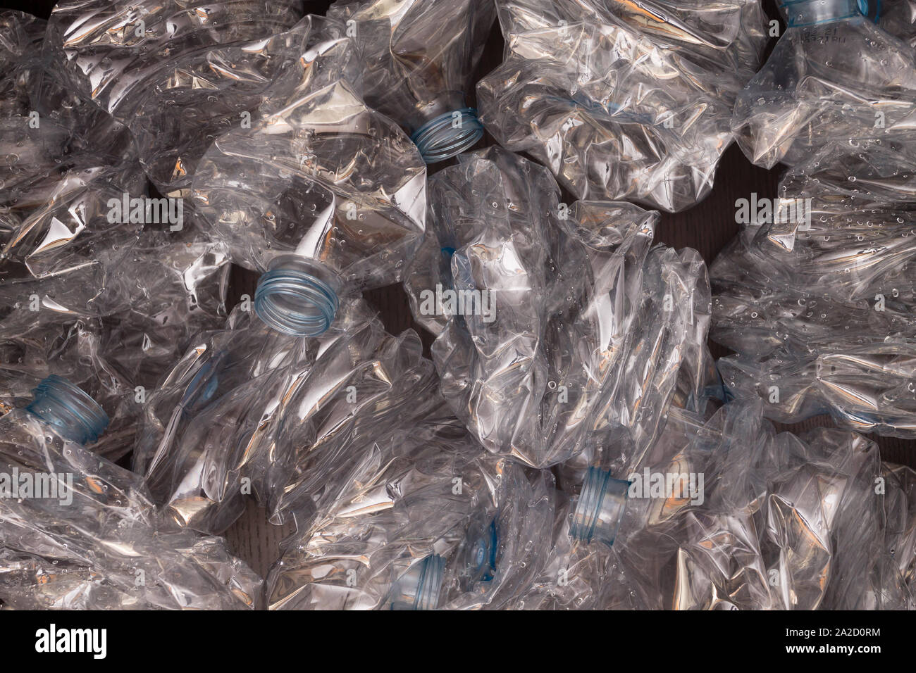 Plastic bottles background. Empty bottles on black surface. Non biodegradable waste Stock Photo