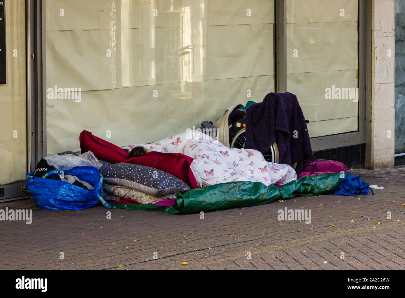 A homeless couple beded down outside an abandoned town centre shop sum up economic down turn Stock Photo