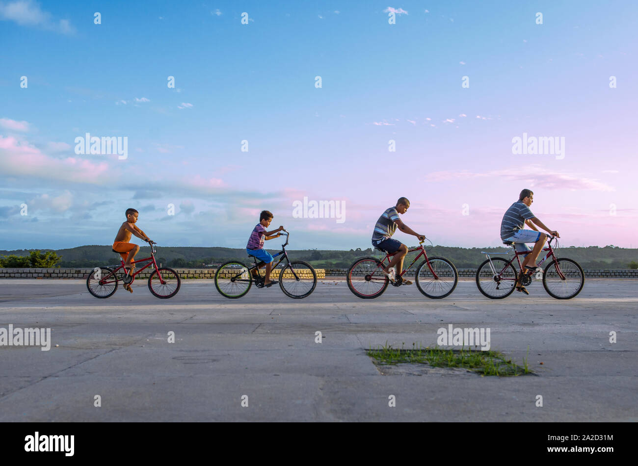 Evolutionary line of cyclers in a row outdoors Stock Photo