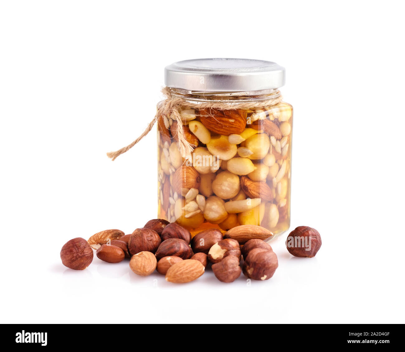 Healthy mix of natural honey with different nuts in a jar on white  background Stock Photo - Alamy