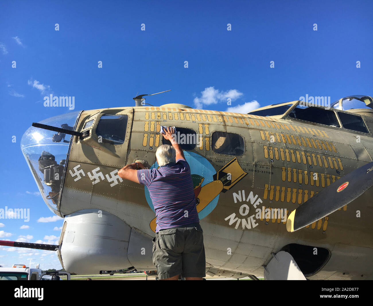The pilot of a Boeing B-17G owned by the Collings Foundation wipes the windows before flying passengers as part of a nation-wide tour of historic aircraft at Chicago Executive Airport in Wheeling, IL on July 29, 2017. The plane was marked as the historic Nine-O-Nine of the 323rd Bomb Squadron, 91st Bomb Group that completed 140 combat missions during World War II. The plane crashed shortly after takeoff with multiple fatalities at Bradley International Airport in Windsor Locks, CT on October 2, 2019. Photo by Brian Kersey/UPI Stock Photo