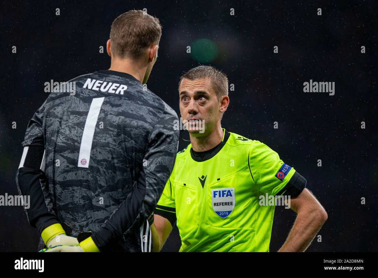 Match referee Clement Turpin speaks to Manuel Neuer during a UEFA