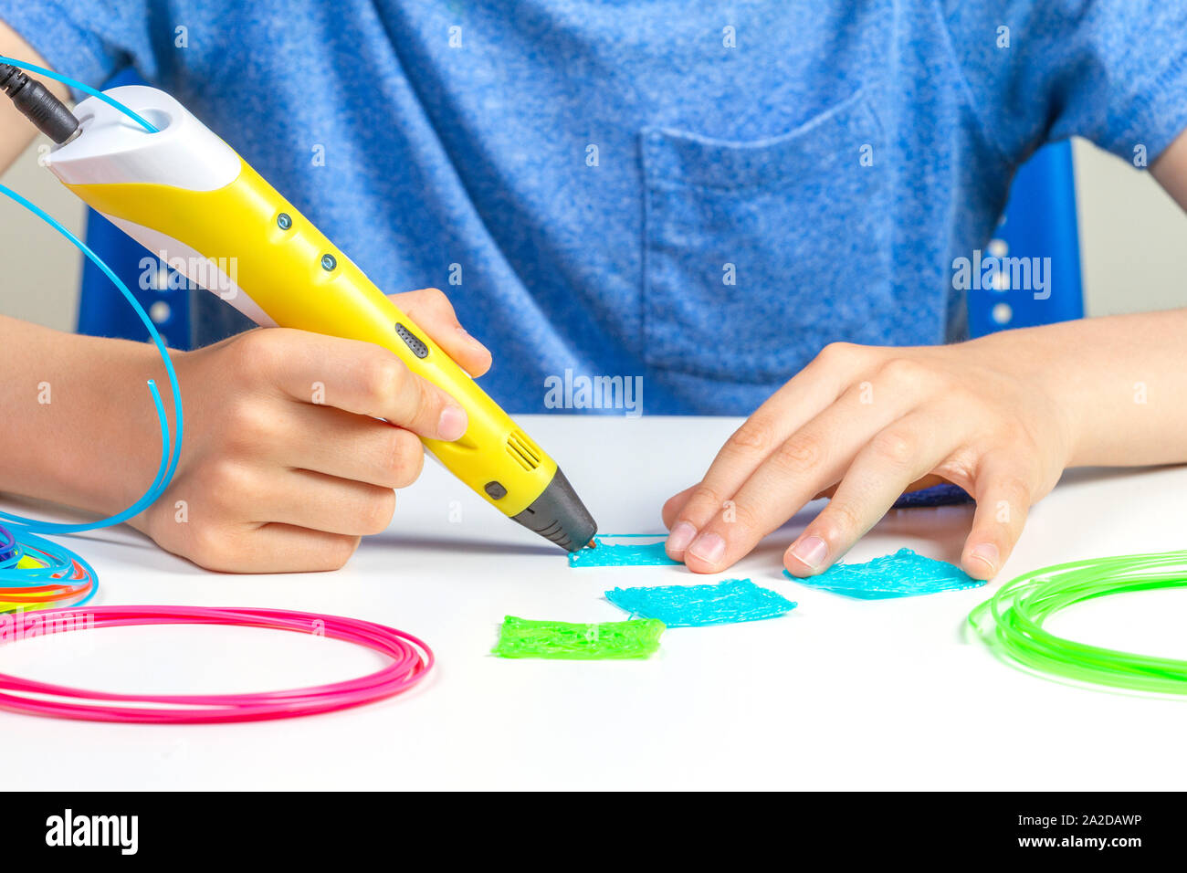 Kid hands creating with 3d printing pen new object Stock Photo - Alamy