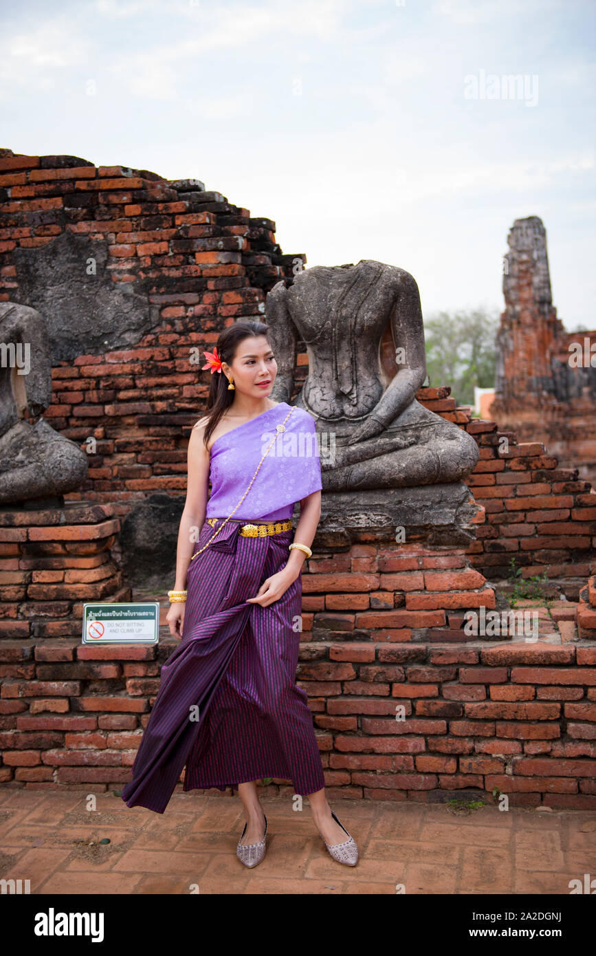 Woman taking a picture with a traditional Thai costume during the Ayut Stock Photo