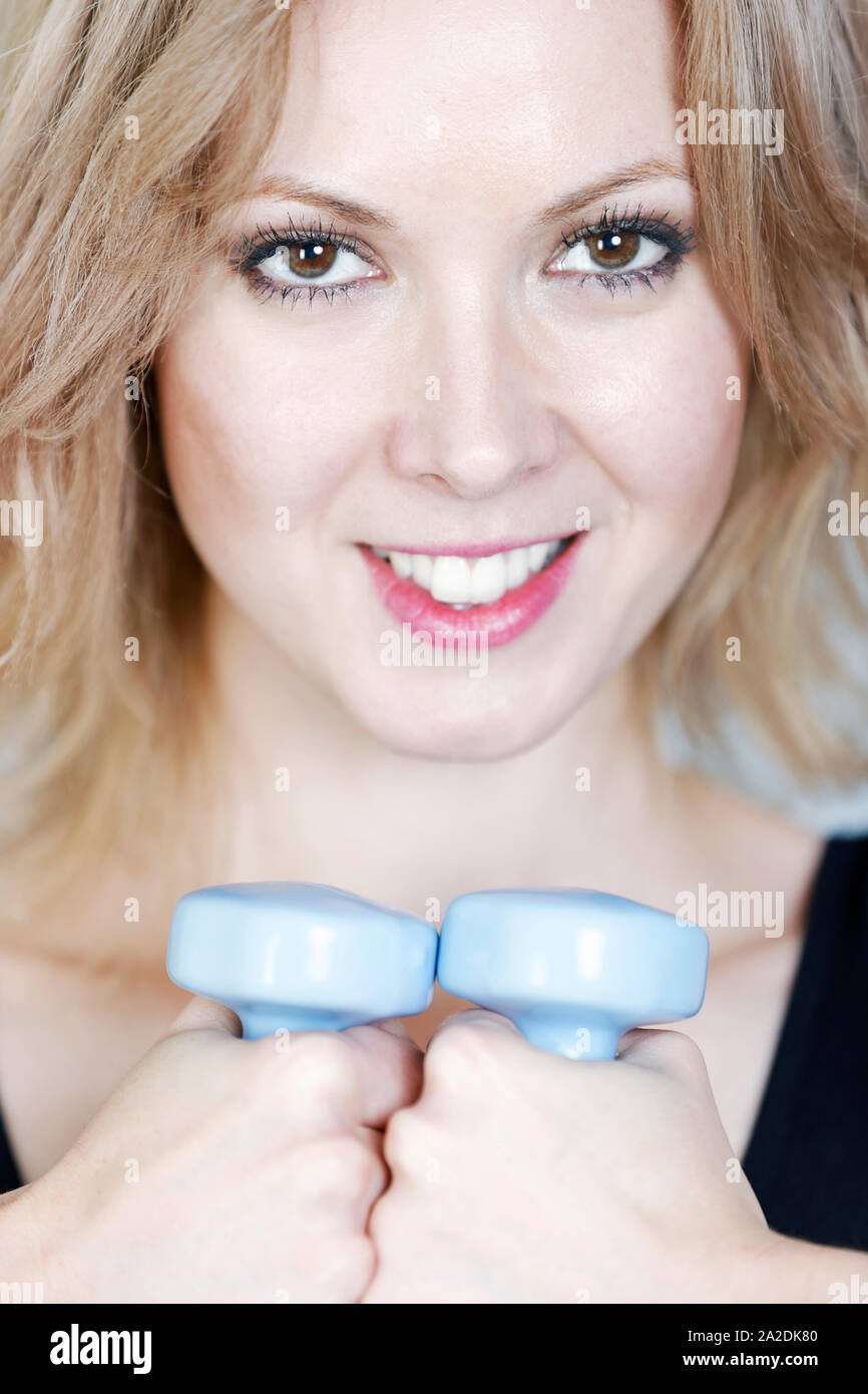 Beautiful young woman weight training Stock Photo Alamy