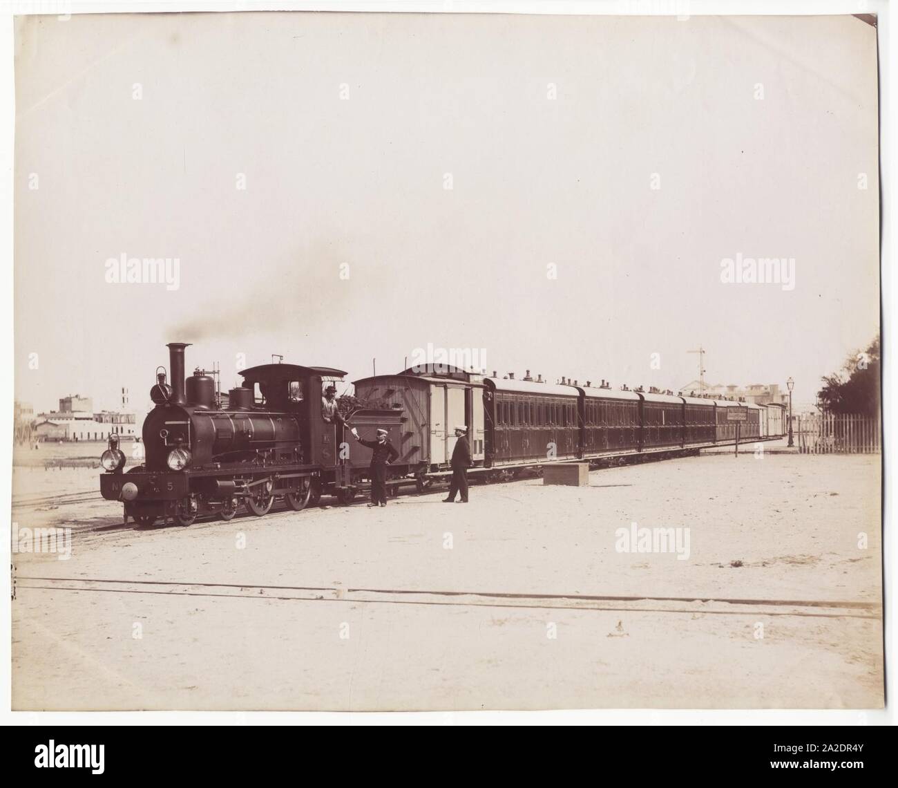 Egypt Railways - Port Said Railway Company - 4-4-0 steam locomotive Nr. V5 (SACM Graffenstaden, 1896) and a passenger train. Stock Photo