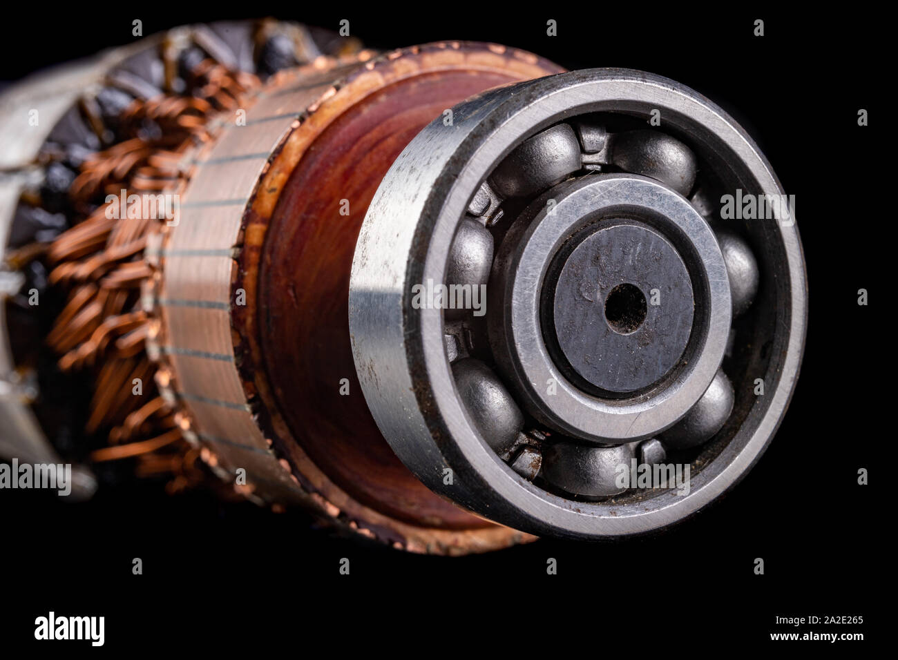 Ball bearing on the motor rotor. Copper motor winding. Dark background