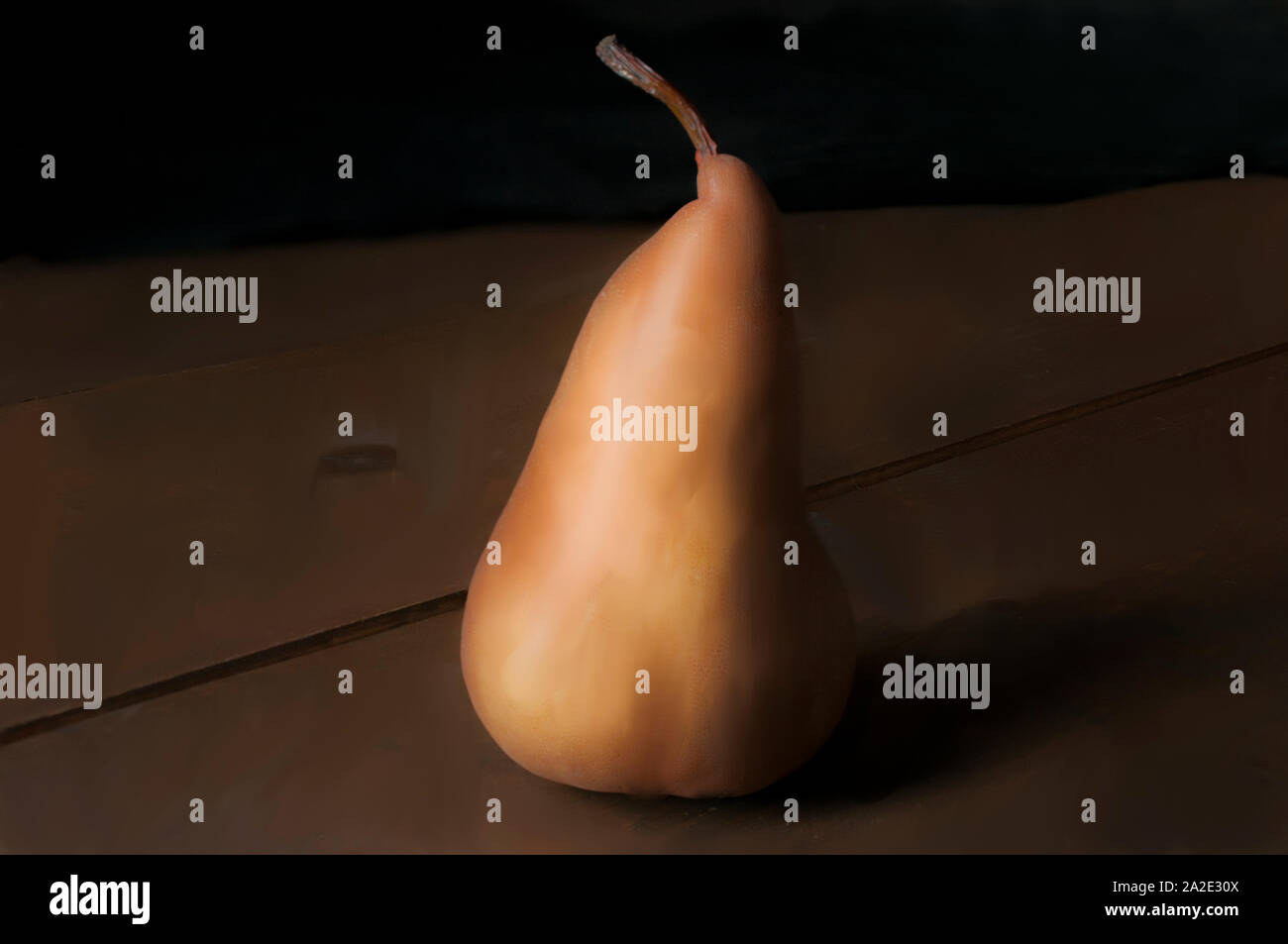 Still life single pear on a wooden rustic table in low key light dark food photography Stock Photo