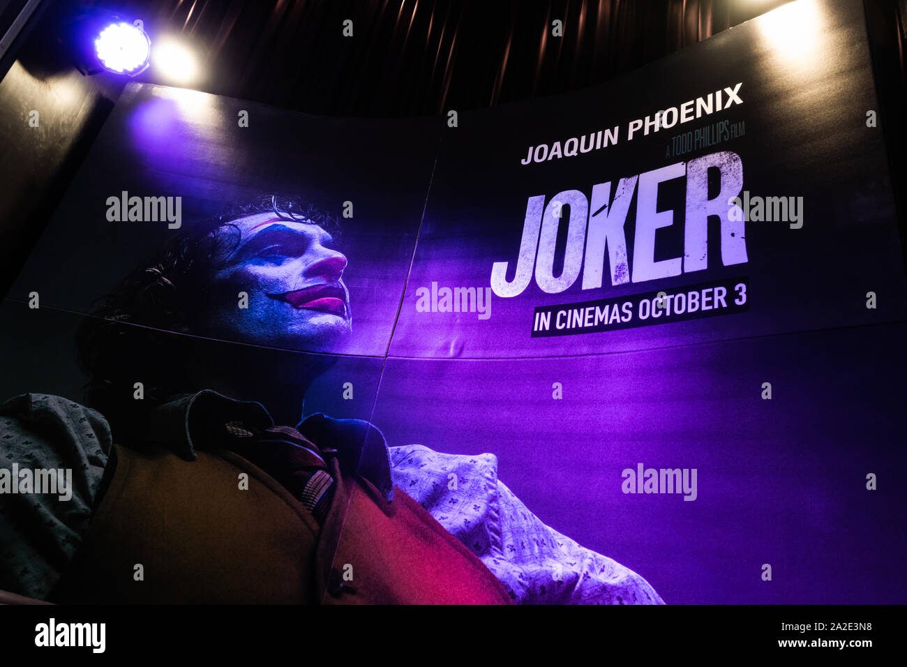 Bangkok, Thailand - Oct 1, 2019: Joker movie backdrop poster with spotlights showing in movie theatre. Cinema promotional advertisement concept Stock Photo