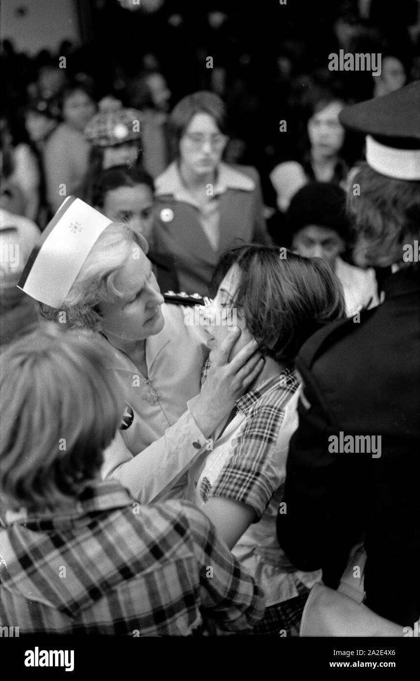 1970s pop concert UK St Johns Ambulance medical staff  nurse giving first aid look after a teenage fans suffering from emotional teenage excitement at Bay City Roller Fans pop group Hammersmith Odeon, west London 1975.  70s England HOMER SYKES Stock Photo