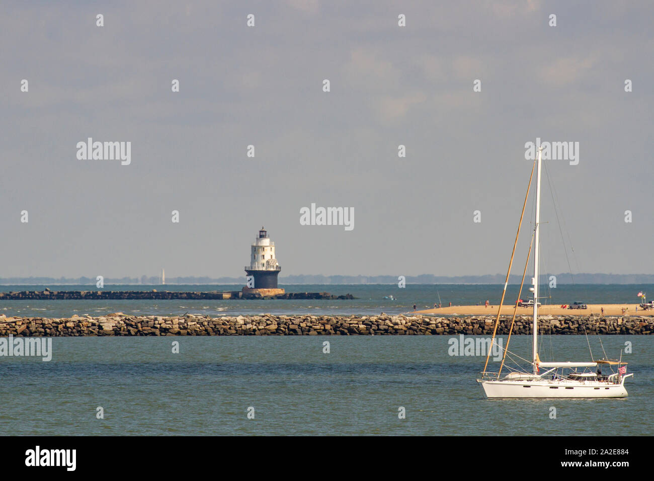 Lewes, Delaware - September 27, 2019 :  Tourists and sailboat at Harbor of Refuge Lighthouse off the coast of Lewes, Delaware in Lewes. Stock Photo