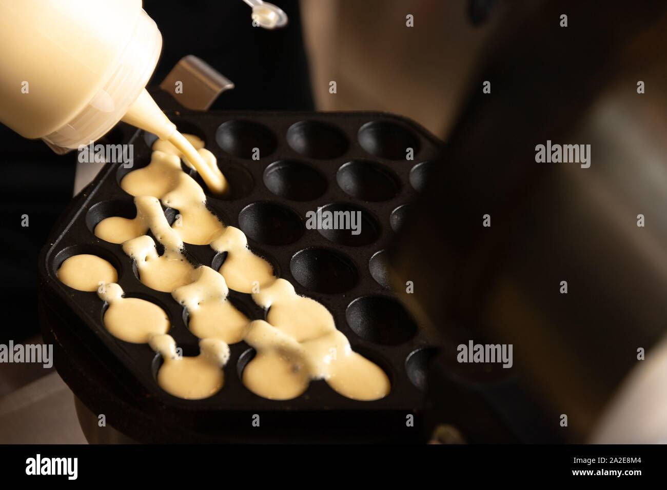Making waffles on dark waffle iron, action shots Stock Photo