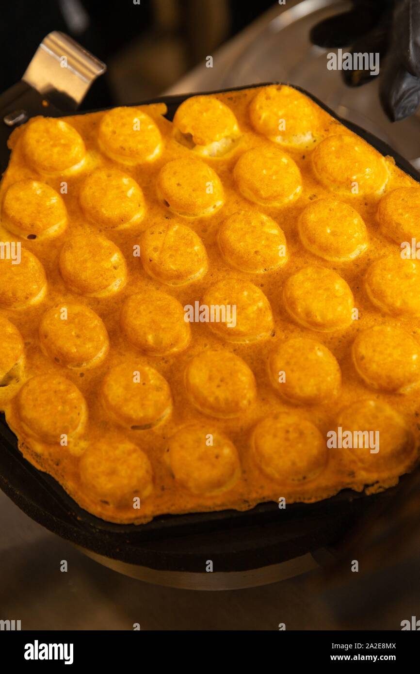 Making waffles on dark waffle iron, action shots Stock Photo Alamy