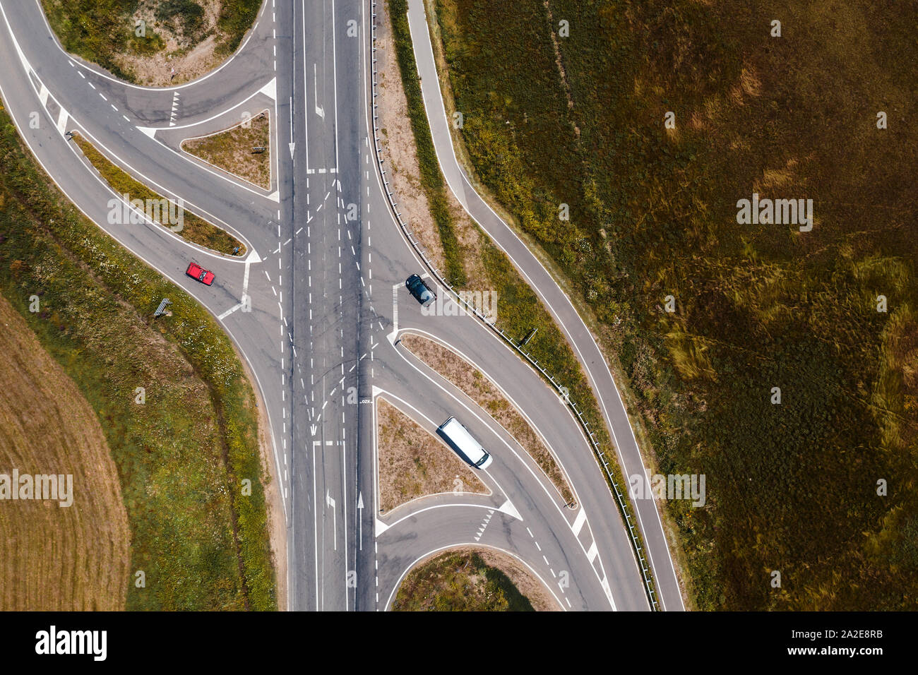 Aerial view of traffic on road intersection with turning lines from drone pov directly above Stock Photo
