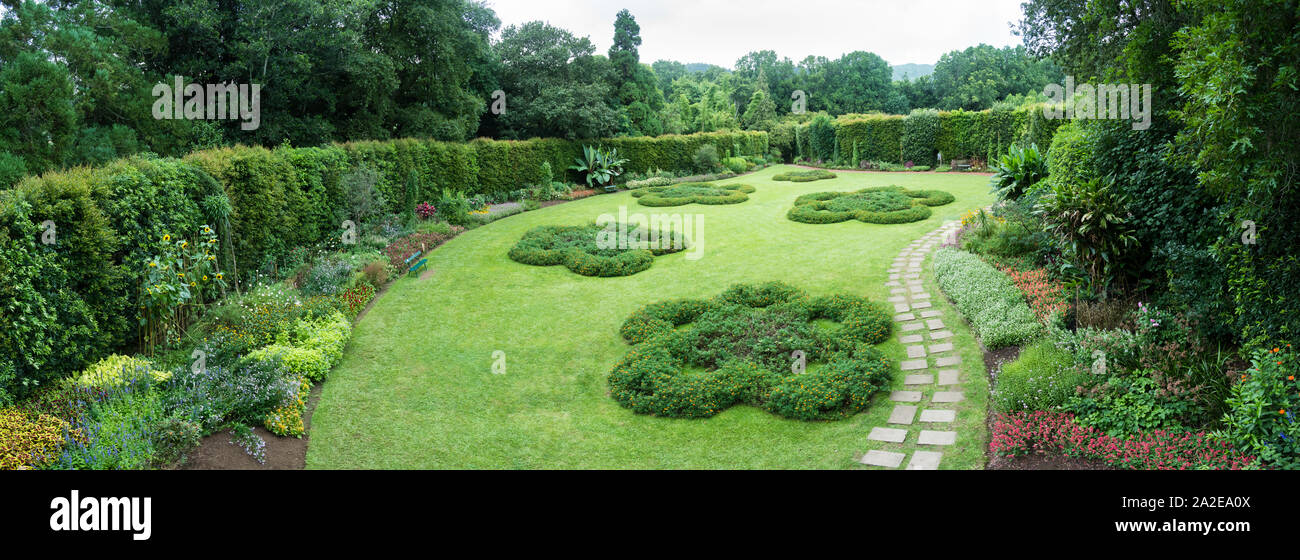 Furnas, Azores - September 02 2019: Panoramic view of the Terra Nostra gardens on the island of São Miguel. Shrub borders surround a grass lawn. Stock Photo