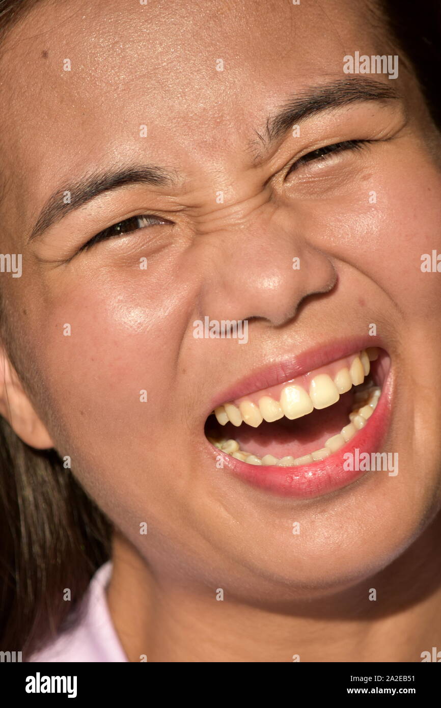 A Laughing Youthful Filipina Female Stock Photo
