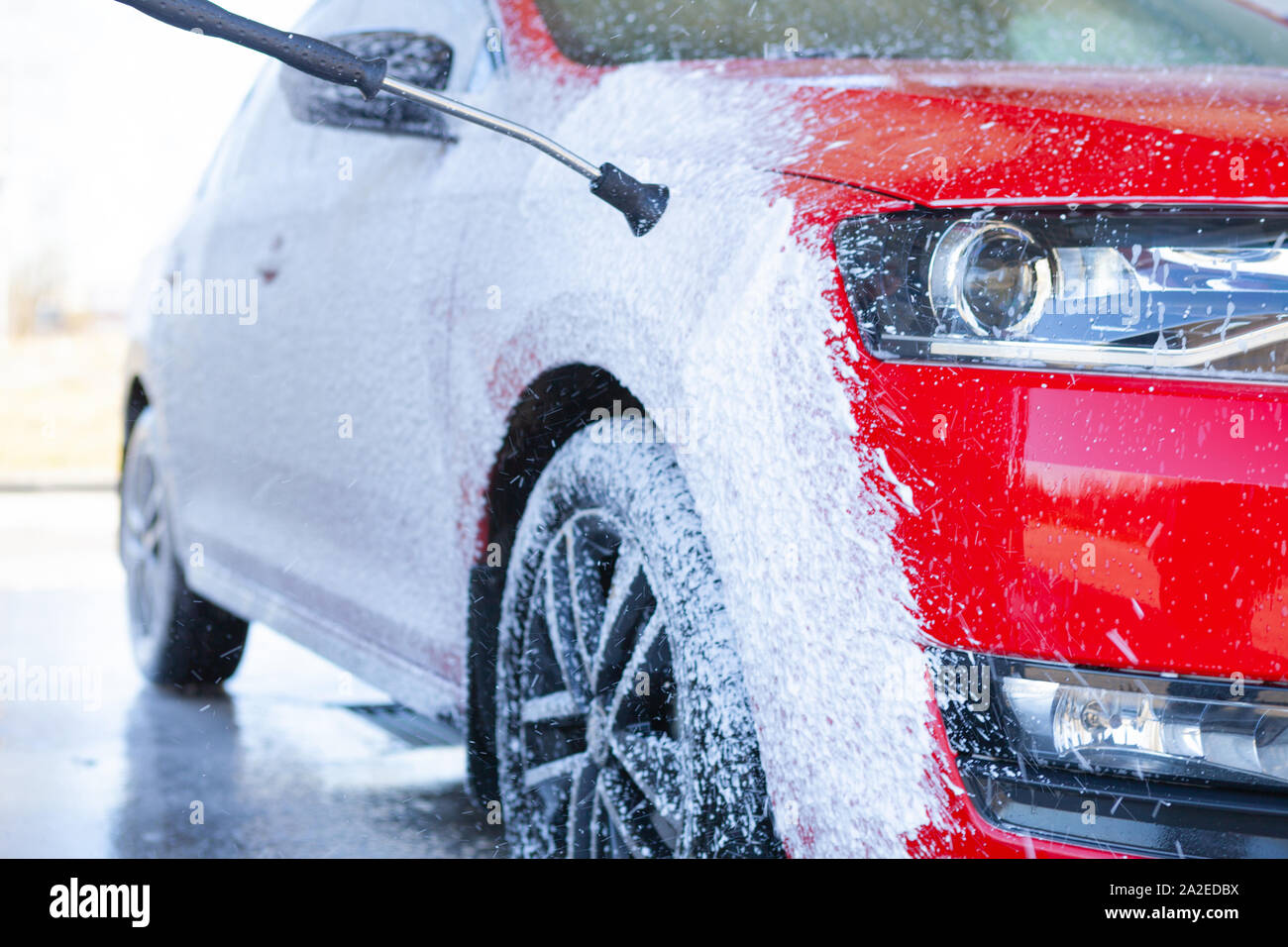 Car cleaning. Wash red car with soap. High pressure water washing Stock Photo Alamy